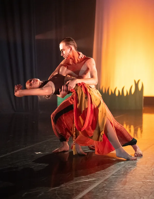 Two dancers performing a supported movement