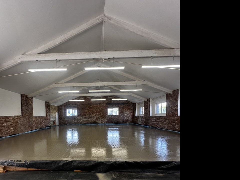 Renovation work in progress inside Vibe’s new premises beneath exposed roof beams