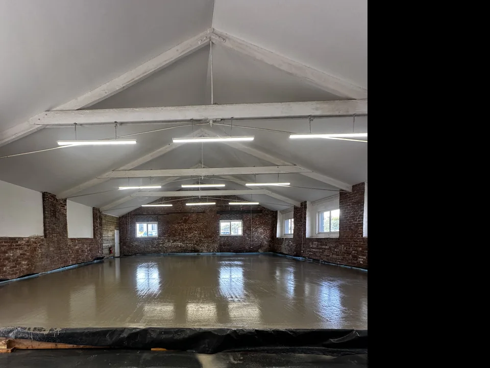 Renovation work in progress inside Vibe’s new premises beneath exposed roof beams